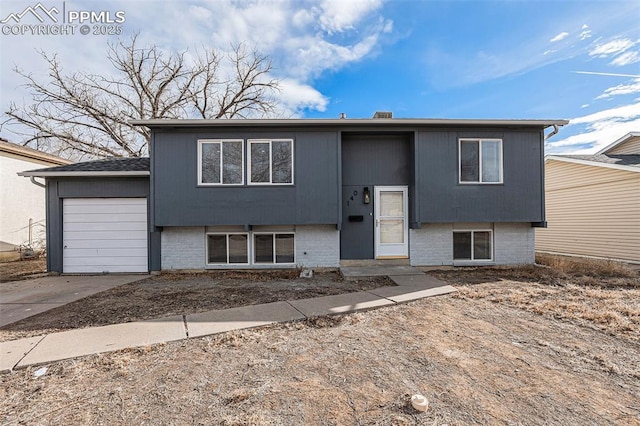 140 Schirra Pl, Pueblo, CO 81001 - bi-level home with driveway, a garage, and brick siding