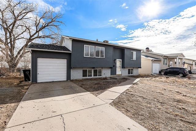 140 Schirra Pl, Pueblo, CO 81001 - raised ranch featuring an attached garage, driveway, and brick siding