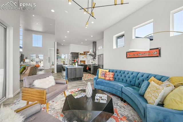 10423 Bergan Peak Ct, Colorado Springs, CO 80924 - living area featuring a high ceiling, light wood-type flooring, recessed lighting, and a chandelier