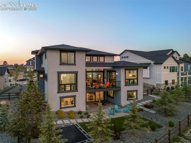 10423 Bergan Peak Ct, Colorado Springs, CO 80924 - rear view of house featuring a patio, stucco siding, and a balcony