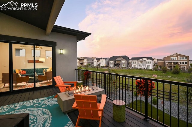 10423 Bergan Peak Ct, Colorado Springs, CO 80924 - balcony at dusk featuring an outdoor living space with a fire pit and a residential view