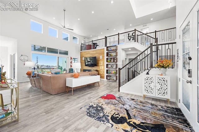 10423 Bergan Peak Ct, Colorado Springs, CO 80924 - living area featuring recessed lighting, a towering ceiling, a ceiling fan, stairs, and wood finished floors