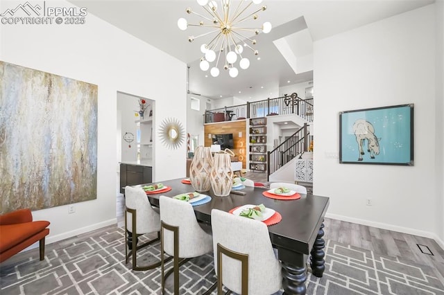 10423 Bergan Peak Ct, Colorado Springs, CO 80924 - dining room featuring a chandelier and stairway