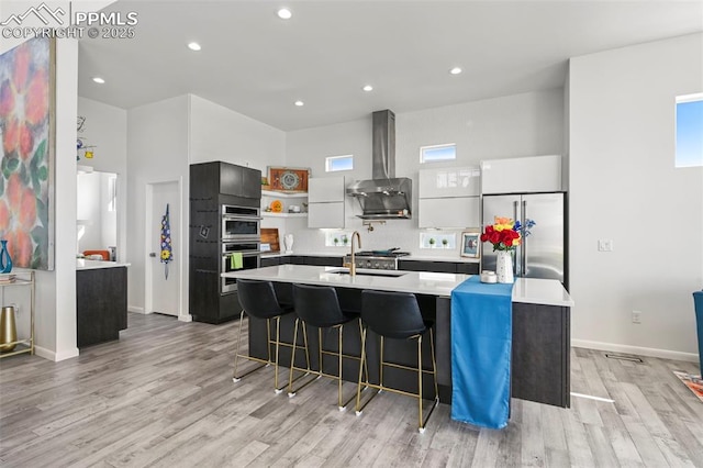10423 Bergan Peak Ct, Colorado Springs, CO 80924 - kitchen with wall chimney exhaust hood, stainless steel appliances, open shelves, light countertops, and recessed lighting