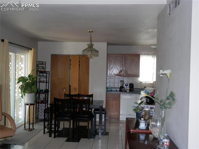 4450 Chaparral Rd, Colorado Springs, CO 80917 - dining area featuring light tile patterned flooring and a chandelier