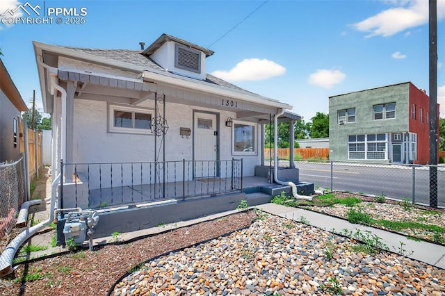 1301 Cypress St, Pueblo, CO 81004 - view of front of property featuring a porch, roof with shingles, and stucco siding