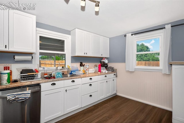 1301 Cypress St, Pueblo, CO 81004 - kitchen featuring dishwasher, dark wood-style floors, wainscoting, white cabinets, and light countertops