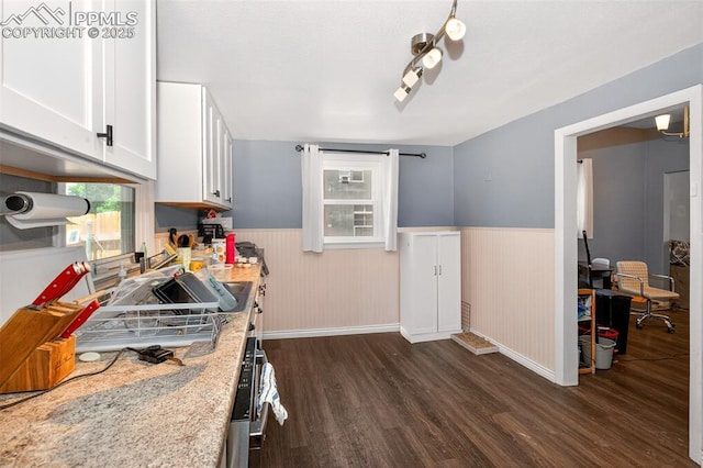 1301 Cypress St, Pueblo, CO 81004 - kitchen featuring dark wood-type flooring, wainscoting, white cabinetry, and light stone counters