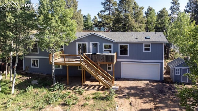 451 Fern Rd, Woodland Park, CO 80863 - view of front of property featuring stairway, a garage, a storage unit, a wooden deck, and driveway