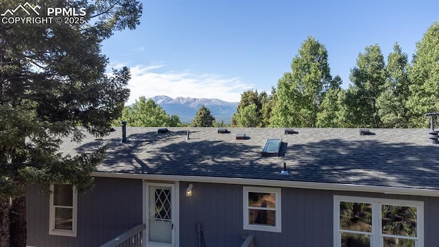 451 Fern Rd, Woodland Park, CO 80863 - back of property with a mountain view and roof with shingles