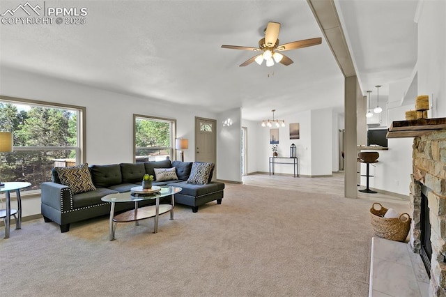 451 Fern Rd, Woodland Park, CO 80863 - living room featuring a ceiling fan, light carpet, a fireplace, and a chandelier