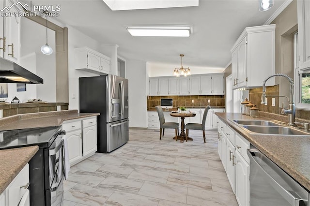 451 Fern Rd, Woodland Park, CO 80863 - kitchen with stainless steel appliances, light marble finish flooring, backsplash, and white cabinets