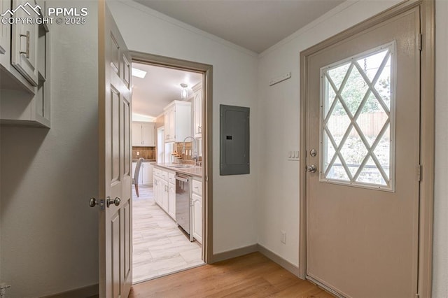 451 Fern Rd, Woodland Park, CO 80863 - doorway to outside featuring electric panel, healthy amount of natural light, crown molding, and light wood finished floors
