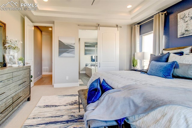 10708 Kentwood Dr, Colorado Springs, CO 80924 - bedroom with a raised ceiling, recessed lighting, a barn door, ensuite bath, and light carpet
