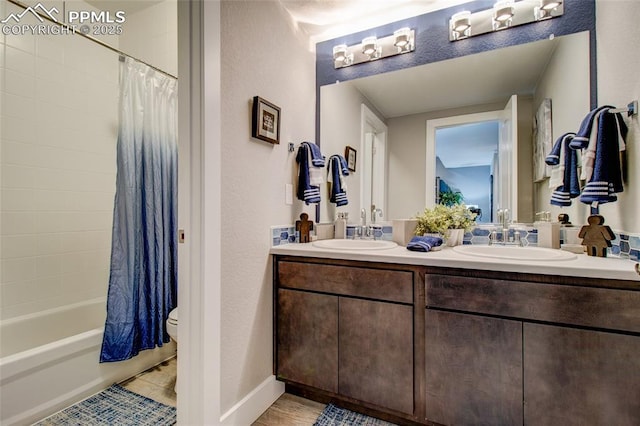 10708 Kentwood Dr, Colorado Springs, CO 80924 - full bath featuring double vanity, shower / bathtub combination with curtain, and a textured wall