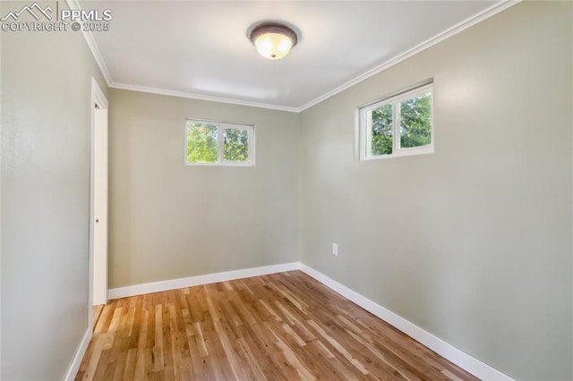 1326 E Platte Ave, Colorado Springs, CO 80909 - empty room featuring healthy amount of natural light, wood finished floors, and crown molding