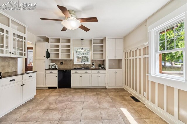 1326 E Platte Ave, Colorado Springs, CO 80909 - kitchen with open shelves, black dishwasher, decorative backsplash, dark countertops, and ceiling fan