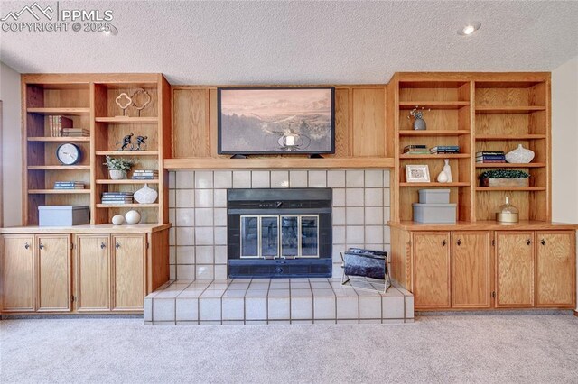 19235 Wakonda Way, Monument, CO 80132 - living area featuring light carpet, a textured ceiling, and a tile fireplace