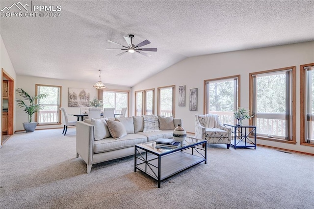 19235 Wakonda Way, Monument, CO 80132 - living area featuring carpet floors, plenty of natural light, a textured ceiling, vaulted ceiling, and ceiling fan