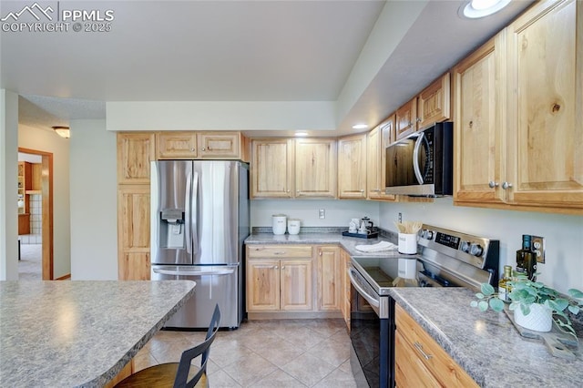 19235 Wakonda Way, Monument, CO 80132 - kitchen featuring appliances with stainless steel finishes, light tile patterned floors, light brown cabinetry, light countertops, and recessed lighting