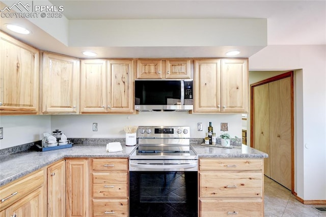 19235 Wakonda Way, Monument, CO 80132 - kitchen featuring appliances with stainless steel finishes, light brown cabinetry, light tile patterned floors, light countertops, and recessed lighting