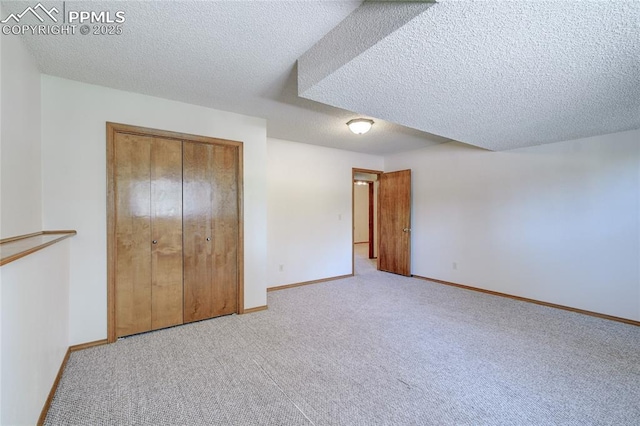 19235 Wakonda Way, Monument, CO 80132 - unfurnished bedroom featuring carpet flooring, a textured ceiling, and a closet