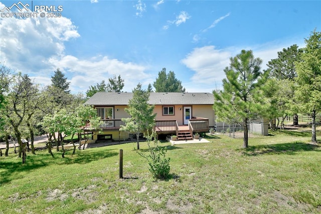 19235 Wakonda Way, Monument, CO 80132 - rear view of house with a deck and a yard