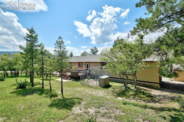19235 Wakonda Way, Monument, CO 80132 - view of green lawn with a deck