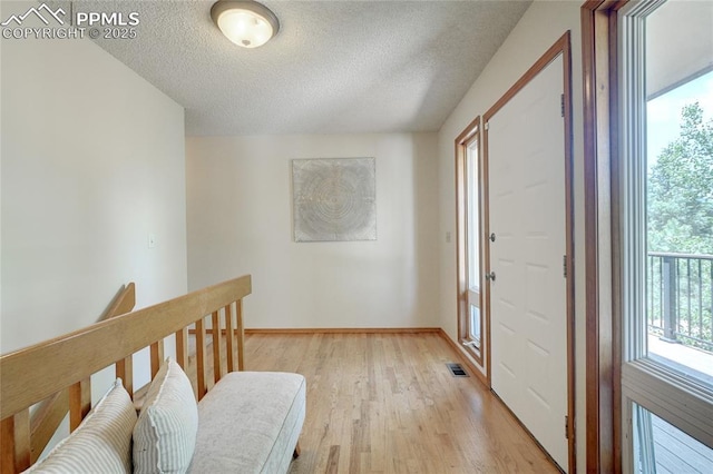 19235 Wakonda Way, Monument, CO 80132 - entrance foyer featuring a textured ceiling and light wood finished floors