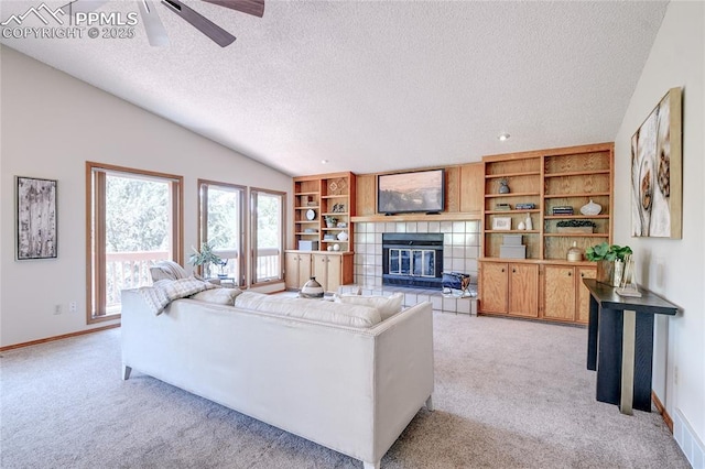 19235 Wakonda Way, Monument, CO 80132 - living room with light carpet, a textured ceiling, a tile fireplace, vaulted ceiling, and a ceiling fan