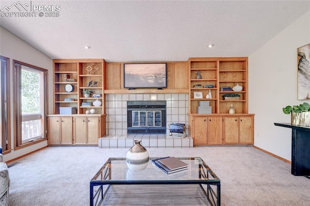 19235 Wakonda Way, Monument, CO 80132 - living area featuring carpet flooring, a textured ceiling, a tiled fireplace, and recessed lighting