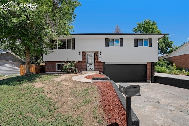 4116 Fitzpatrick Dr, Colorado Springs, CO 80909 - raised ranch with concrete driveway, a garage, brick siding, and stucco siding