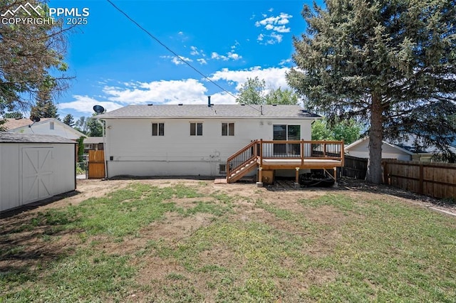 4116 Fitzpatrick Dr, Colorado Springs, CO 80909 - back of property with a fenced backyard, a deck, a storage unit, and stairway