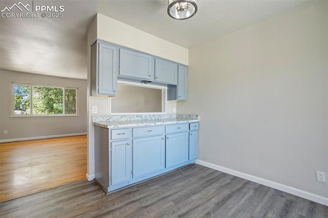 4116 Fitzpatrick Dr, Colorado Springs, CO 80909 - kitchen with baseboards and wood finished floors