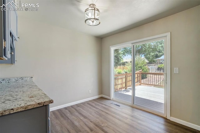 4116 Fitzpatrick Dr, Colorado Springs, CO 80909 - unfurnished dining area featuring dark wood-style floors and a chandelier