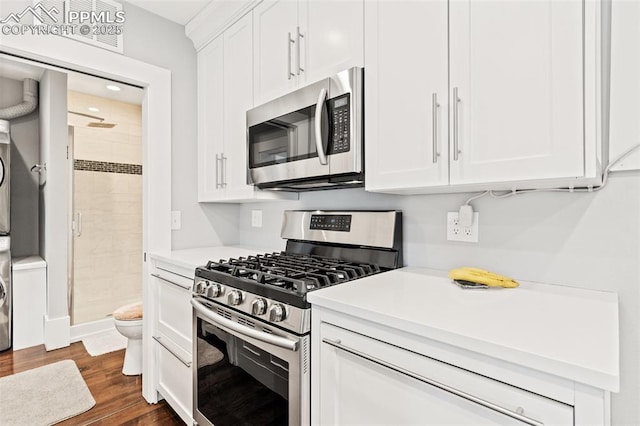 112 N 12th St, Colorado Springs, CO 80904 - kitchen with stainless steel appliances, light countertops, white cabinetry, and dark wood-style flooring