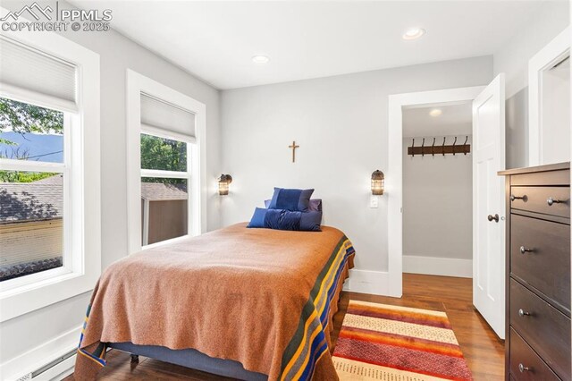 112 N 12th St, Colorado Springs, CO 80904 - bedroom with wood finished floors, a baseboard radiator, and recessed lighting