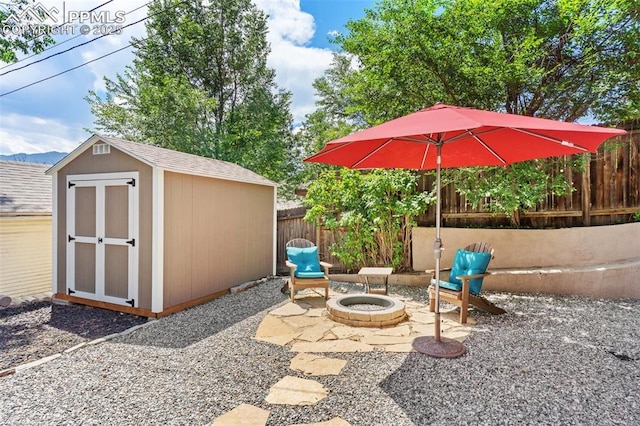 112 N 12th St, Colorado Springs, CO 80904 - view of patio with an outdoor fire pit and a storage unit