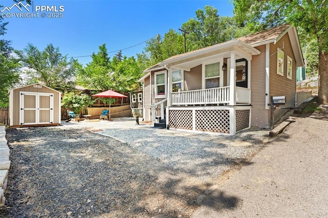 112 N 12th St, Colorado Springs, CO 80904 - view of front of house with covered porch and a storage shed