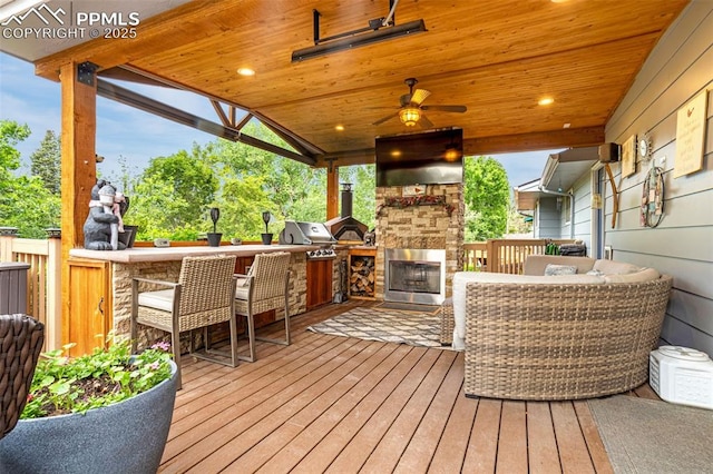 4750 Iron Horse Trl, Colorado Springs, CO 80917 - wooden deck featuring an outdoor stone fireplace and a grill