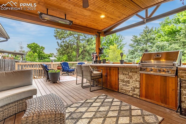 4750 Iron Horse Trl, Colorado Springs, CO 80917 - wooden deck featuring exterior bar, exterior kitchen, and outdoor lounge area