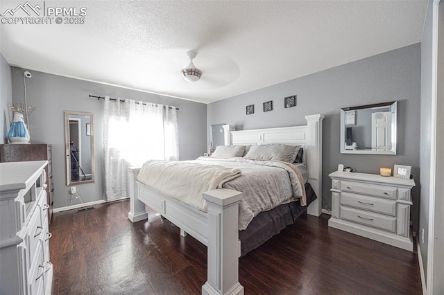 11310 Falling Star Rd, Fountain, CO 80817 - bedroom featuring dark wood-style flooring, a ceiling fan, and a textured ceiling