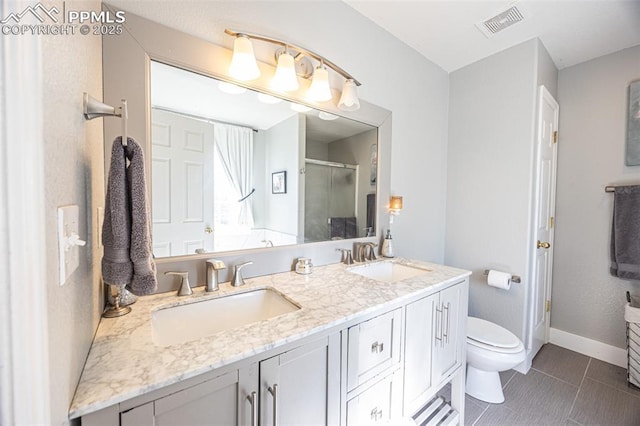 11310 Falling Star Rd, Fountain, CO 80817 - bathroom with a shower stall, double vanity, and tile patterned floors