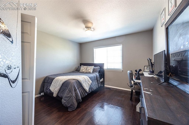 11310 Falling Star Rd, Fountain, CO 80817 - bedroom with dark wood finished floors, a ceiling fan, and a textured ceiling
