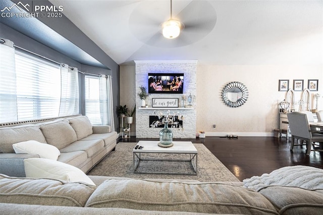 11310 Falling Star Rd, Fountain, CO 80817 - living room featuring wood finished floors, ceiling fan, lofted ceiling, and a stone fireplace