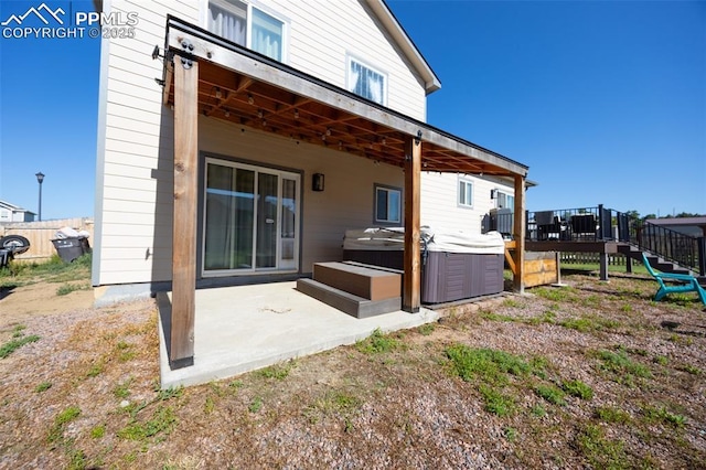11310 Falling Star Rd, Fountain, CO 80817 - rear view of property with a hot tub, a patio, and a deck