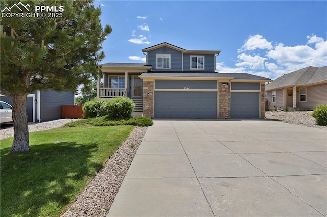 9344 Hirono Rd, Peyton, CO 80831 - split level home featuring a front lawn, driveway, stone siding, and covered porch