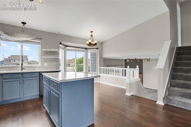 9344 Hirono Rd, Peyton, CO 80831 - kitchen featuring dark wood-style flooring, light countertops, blue cabinets, and healthy amount of natural light