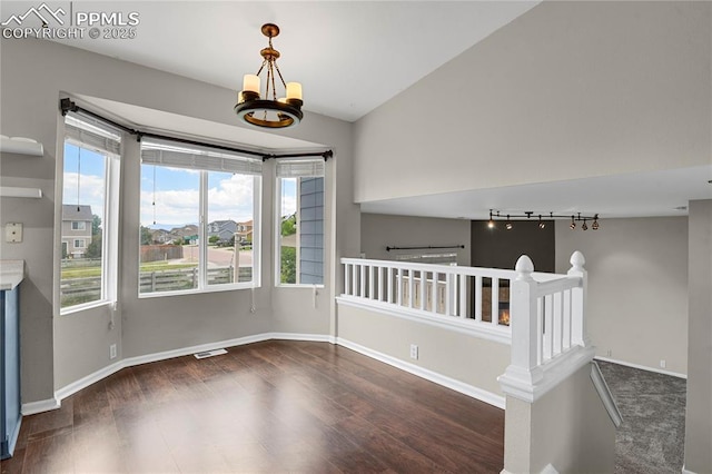 9344 Hirono Rd, Peyton, CO 80831 - spare room with wood finished floors, rail lighting, and a chandelier