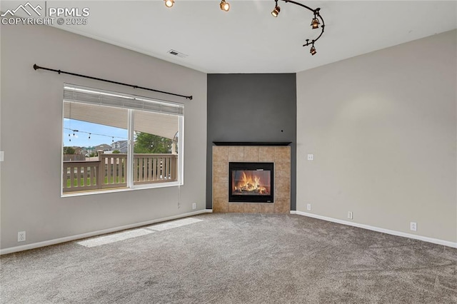9344 Hirono Rd, Peyton, CO 80831 - unfurnished living room featuring carpet floors and a tile fireplace